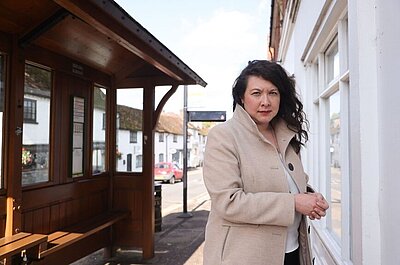 VC standing by bus stop