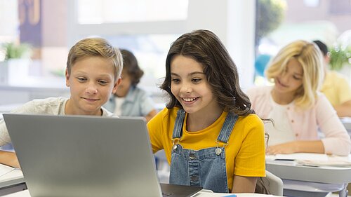 Children using a laptop in school